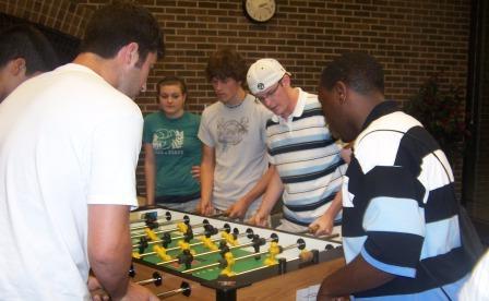 6 GVSU students playing Foosball
