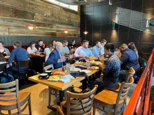 Alumni gather around a table at a restaurant in Washington DC