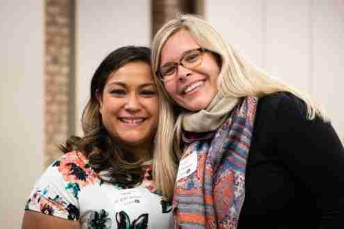 Two women smile 