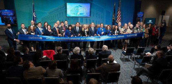 A group of GVSU and community leaders cutting a ribbon.