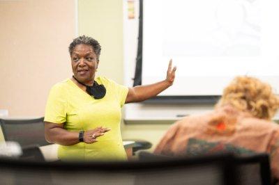 Faye Richardson-Green speaks with students during her honors seminar class