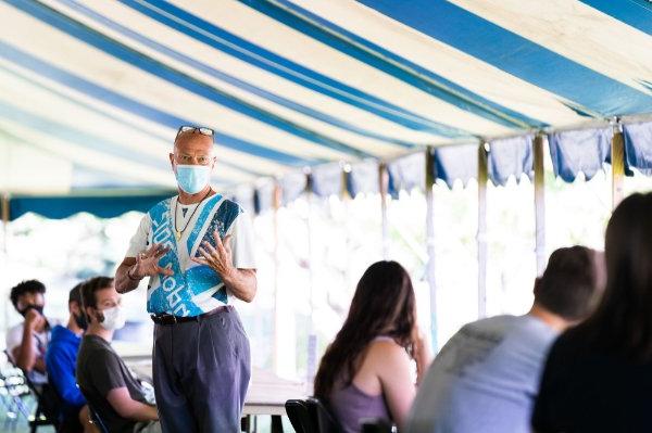 约翰·基尔孟, professor of movement science, teaches a class under a tent near Kindschi Hall of Science. 