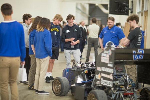 group of students look at the Laker Racing Club car