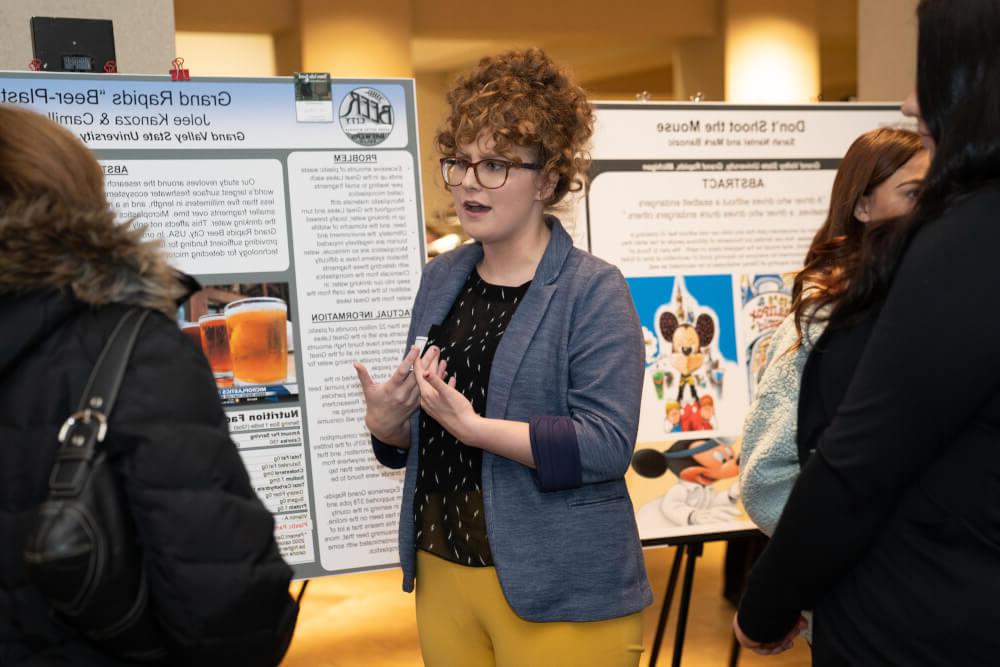A photo of a female student presenting her research.