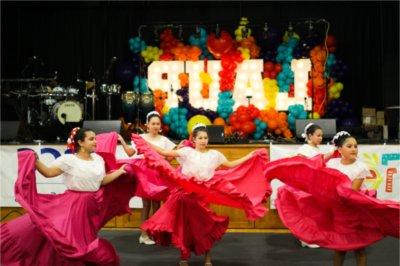 Four girls dance as part of Latin Americans United for Progress's 2023 Fiesta Week.